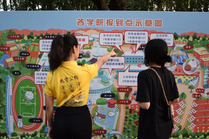 图为志愿者为新生介绍校园示意图 图为志愿者为新生介绍校园示意图