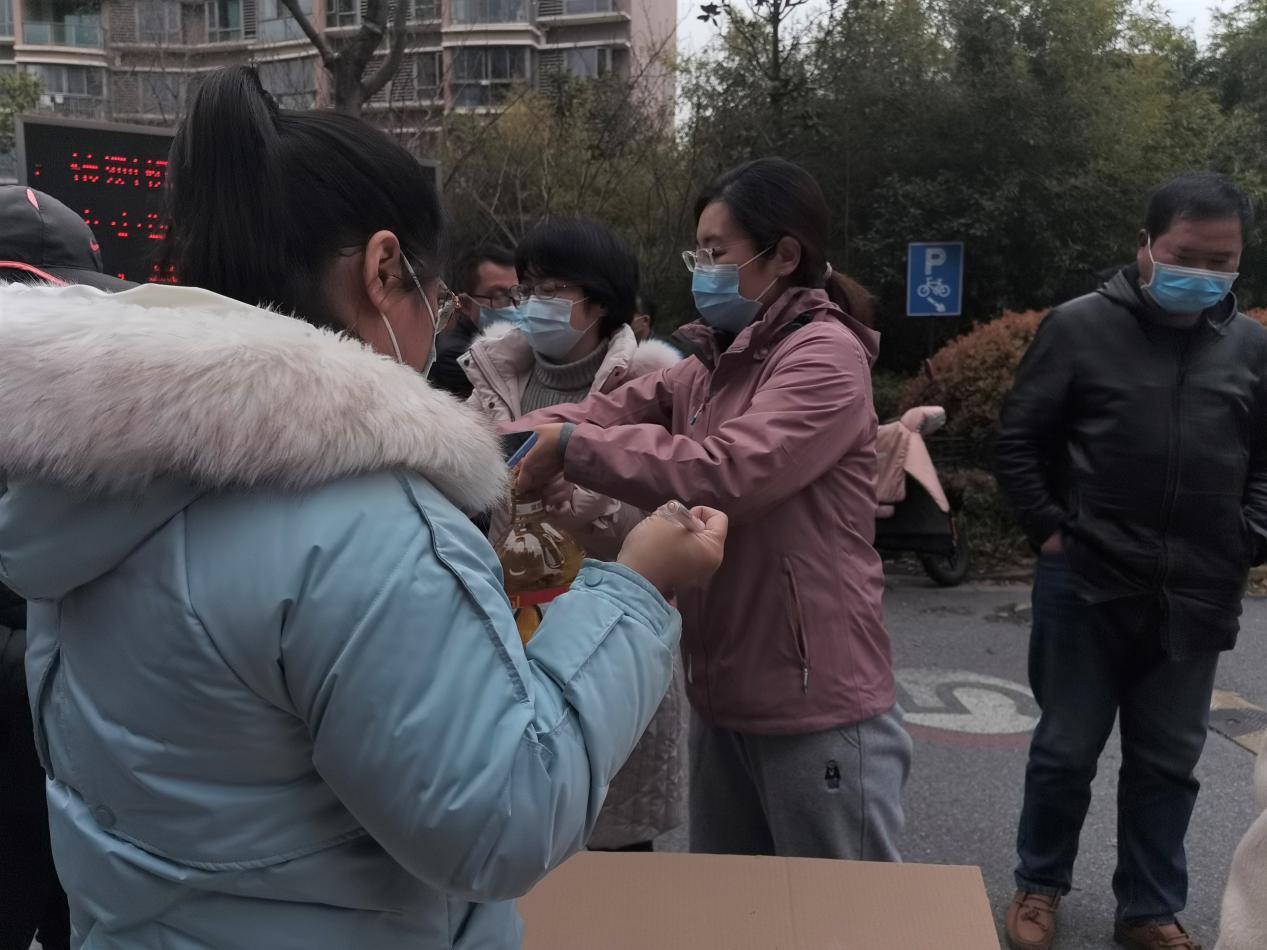 图为焦玥老师为封闭社区清点物资