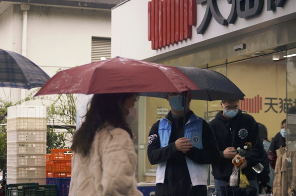 图为超市前的志愿者